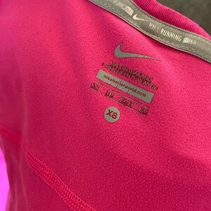hot pink Nike running shirt.